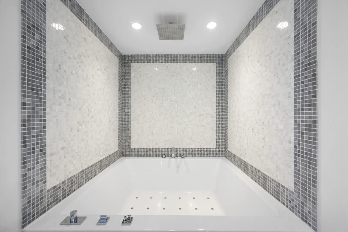 There is a large bathtub in the middle of the bathroom.