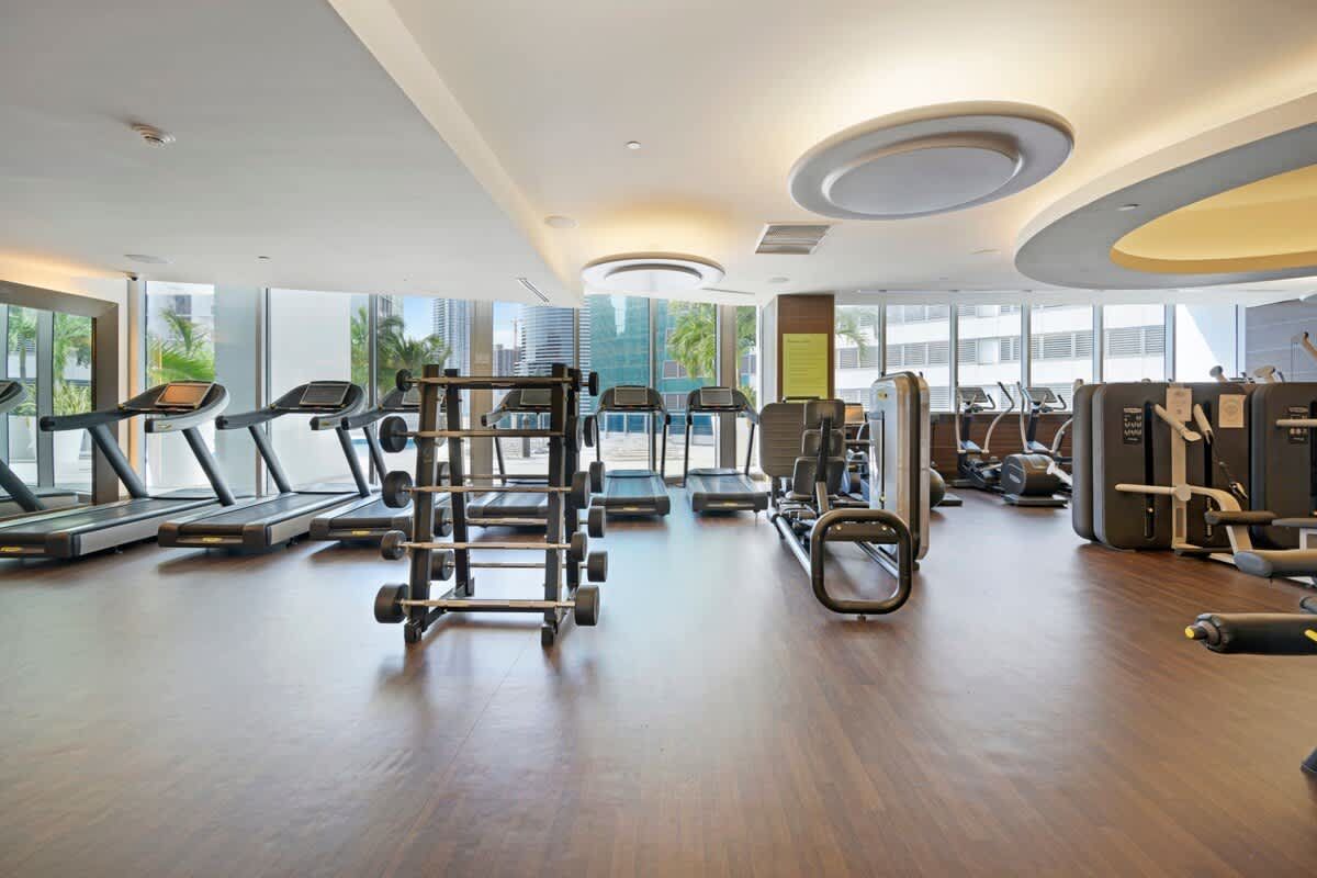 A large gym with a lot of treadmills and exercise equipment.