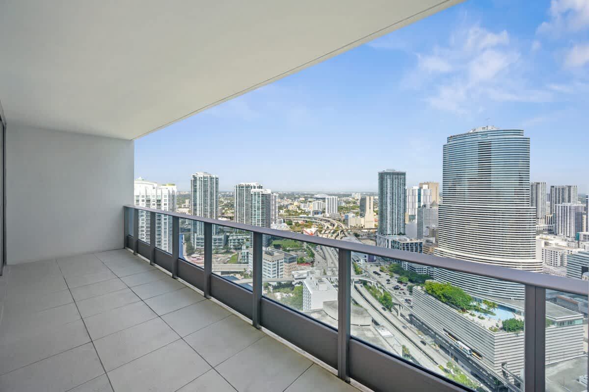 There is a balcony with a view of the city.
