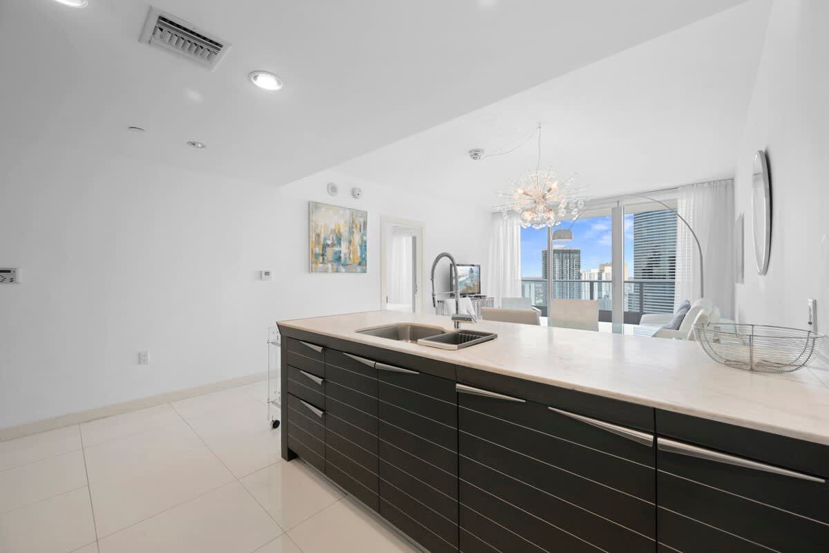 A kitchen with a large island and a sink.