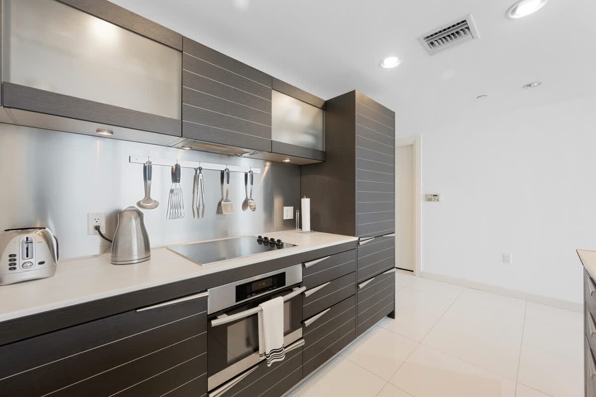 A kitchen with stainless steel appliances and wooden cabinets