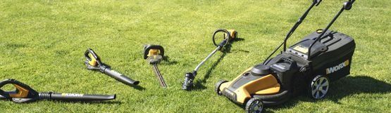 Una cortadora de césped está colocada encima de un césped verde y exuberante.