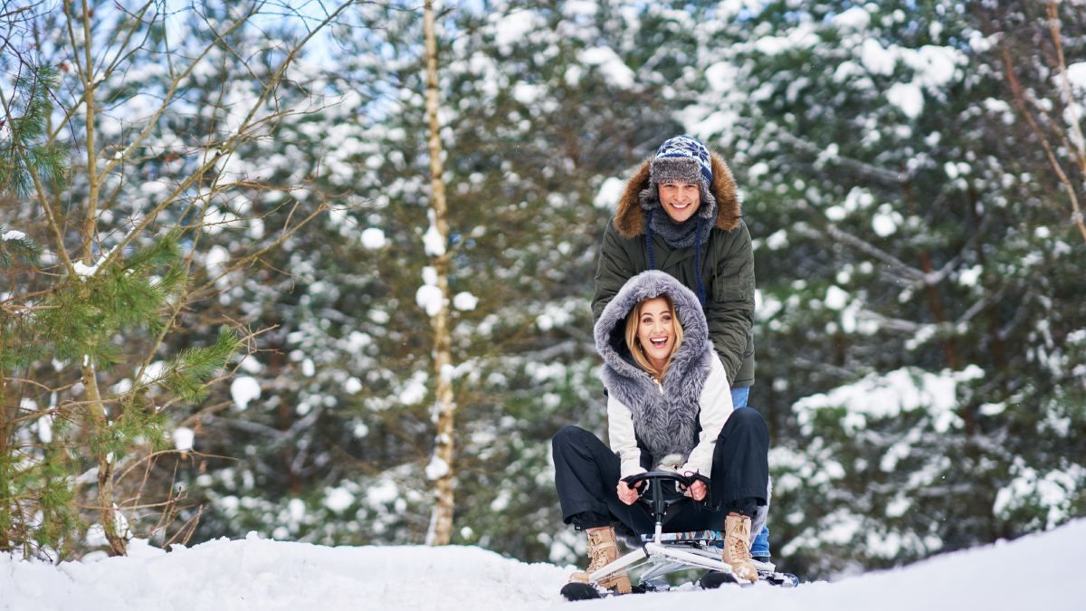 Couple enjoy Valentine's Day in Tahoe in a sleigh ride, a romantic activity that offers scenic views and the charming sound of sleigh bells