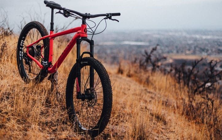 Red bike on mountain slope in autumn