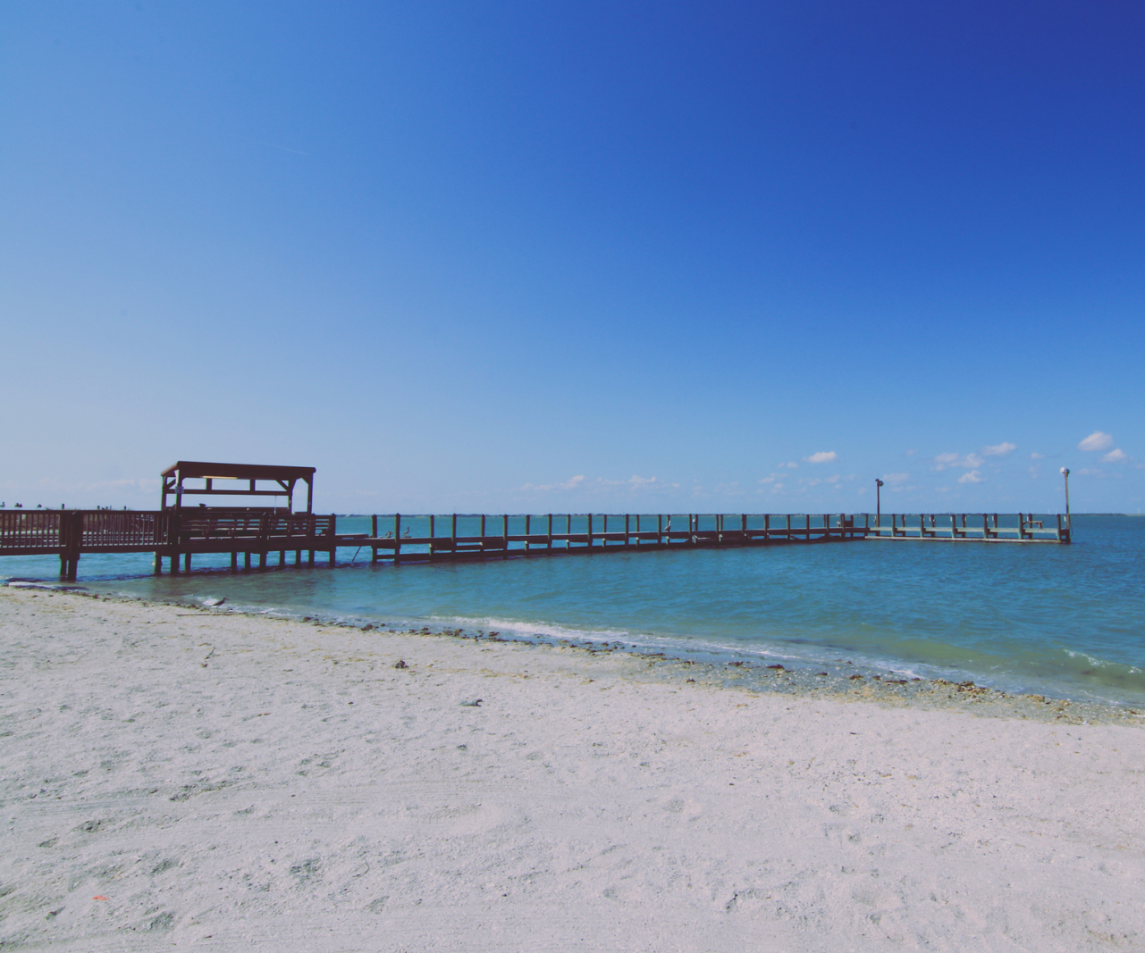 There is a pier in the middle of the ocean in Mustang Isle, Port Aransas.