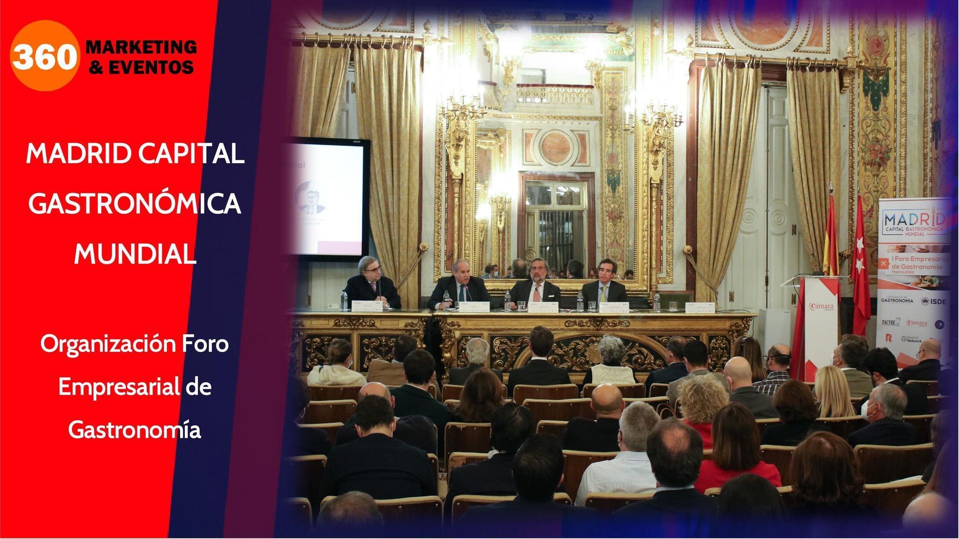 Mesa redonda: Madrid, Capital Gastronómica. El público observa a los ponentes en un evento formal. Decoración en rojo y dorado.