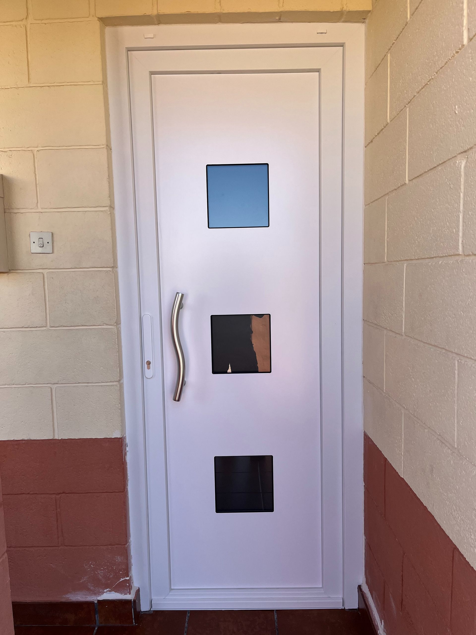 Una puerta blanca con tres cuadrados.