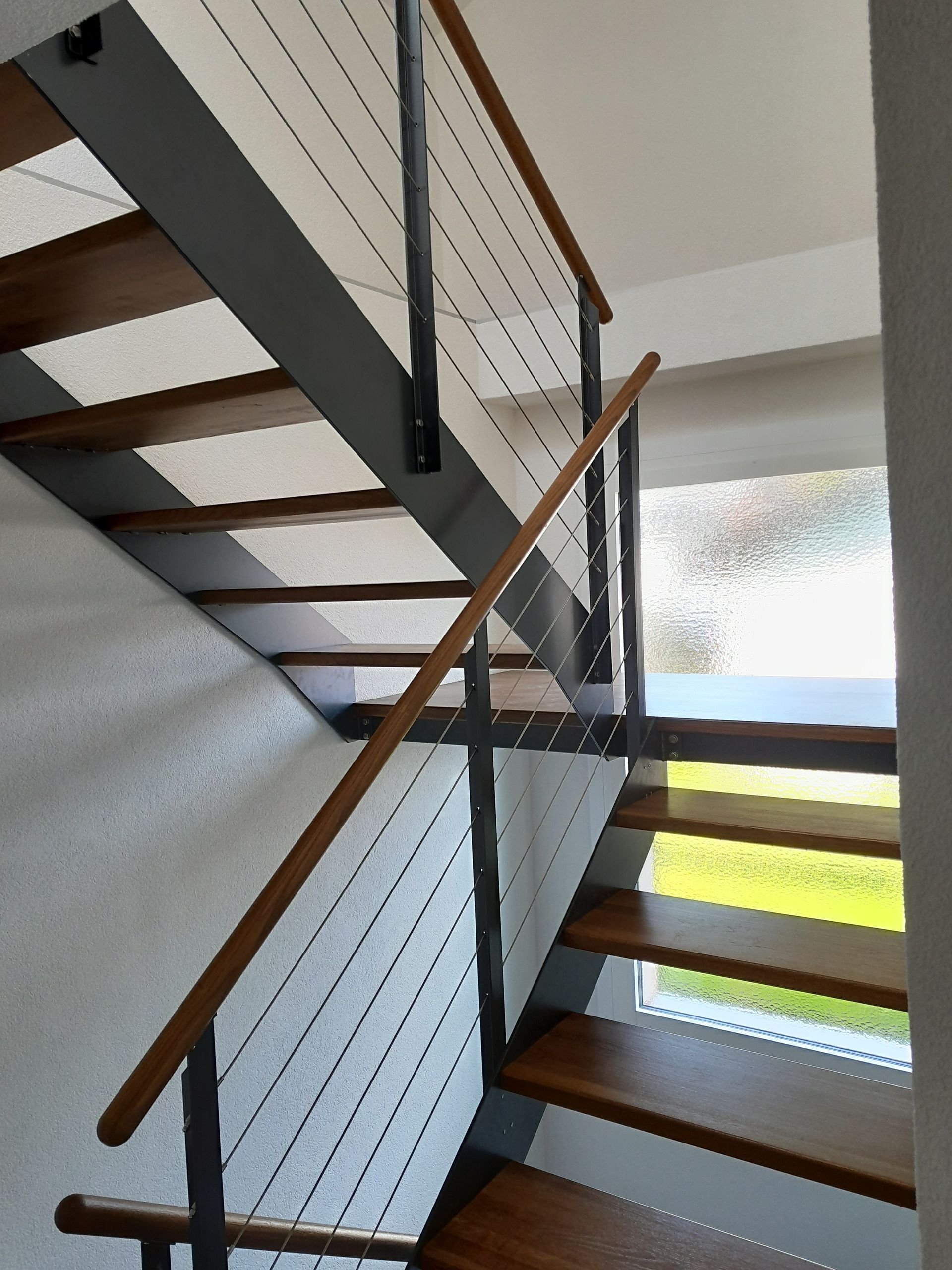 Eine Treppe mit Geländer aus Glas und Edelstahl. Foto von Stefan Hans Zahner