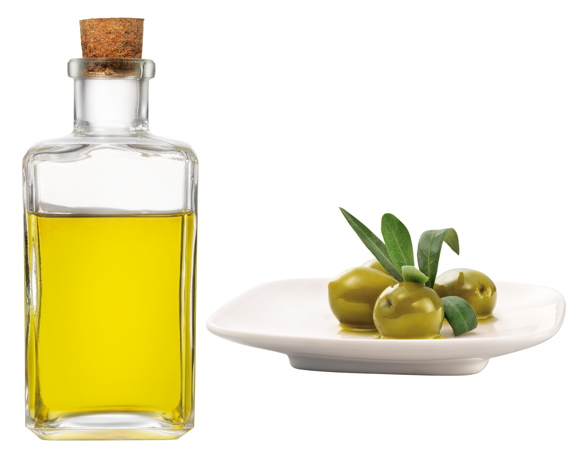 Un flacon d'huile avec des olives à côté