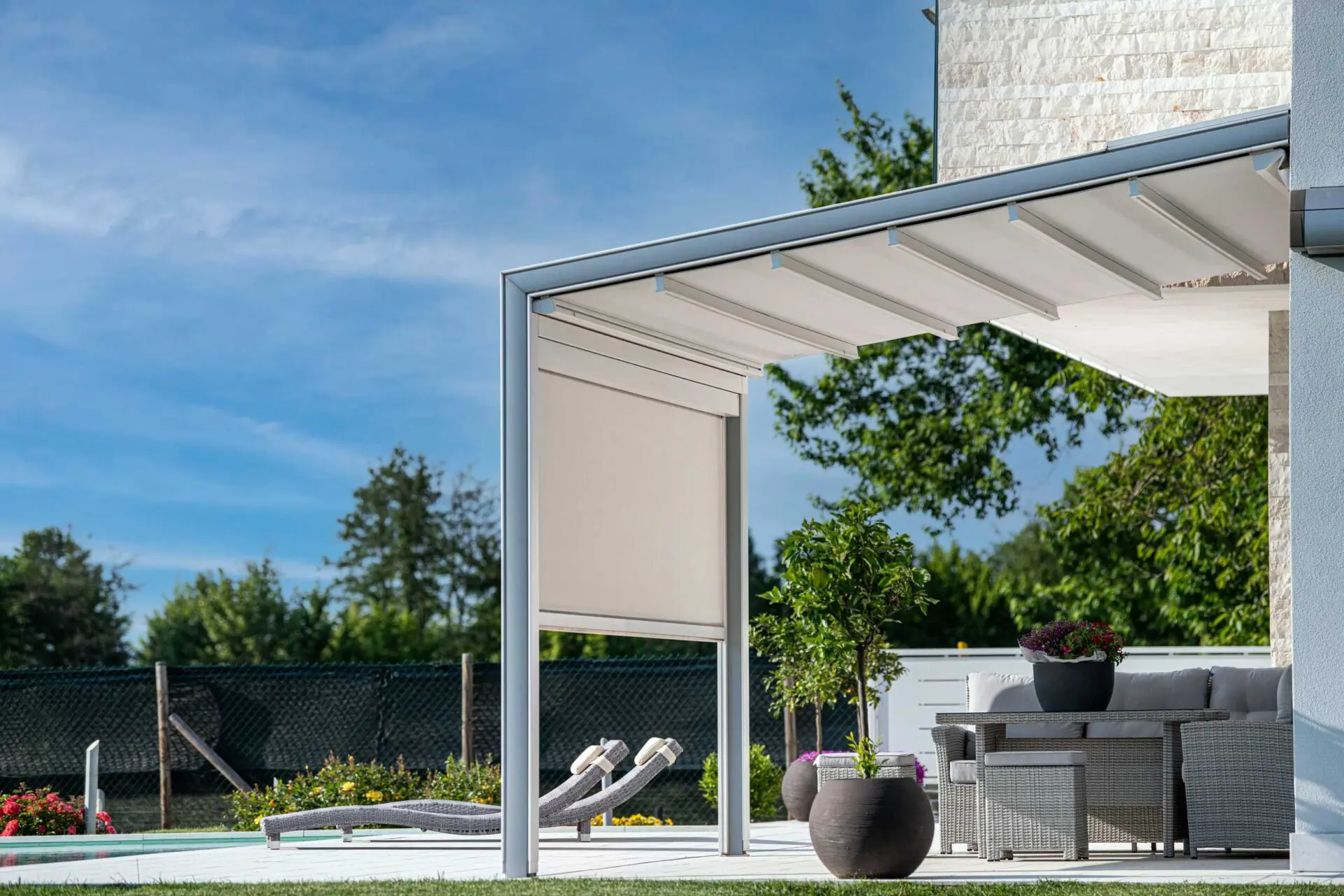 Une pergola inclinée et des transats.