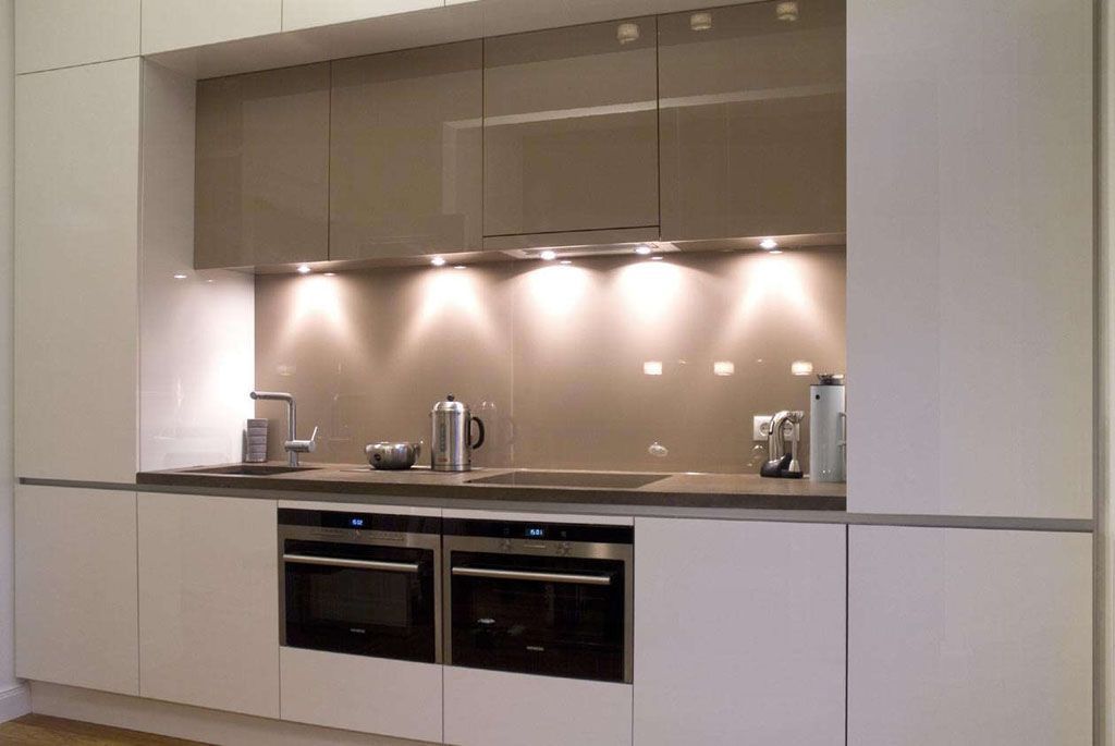 Eine Küche mit weißen Schränken und Geräten aus Edelstahl