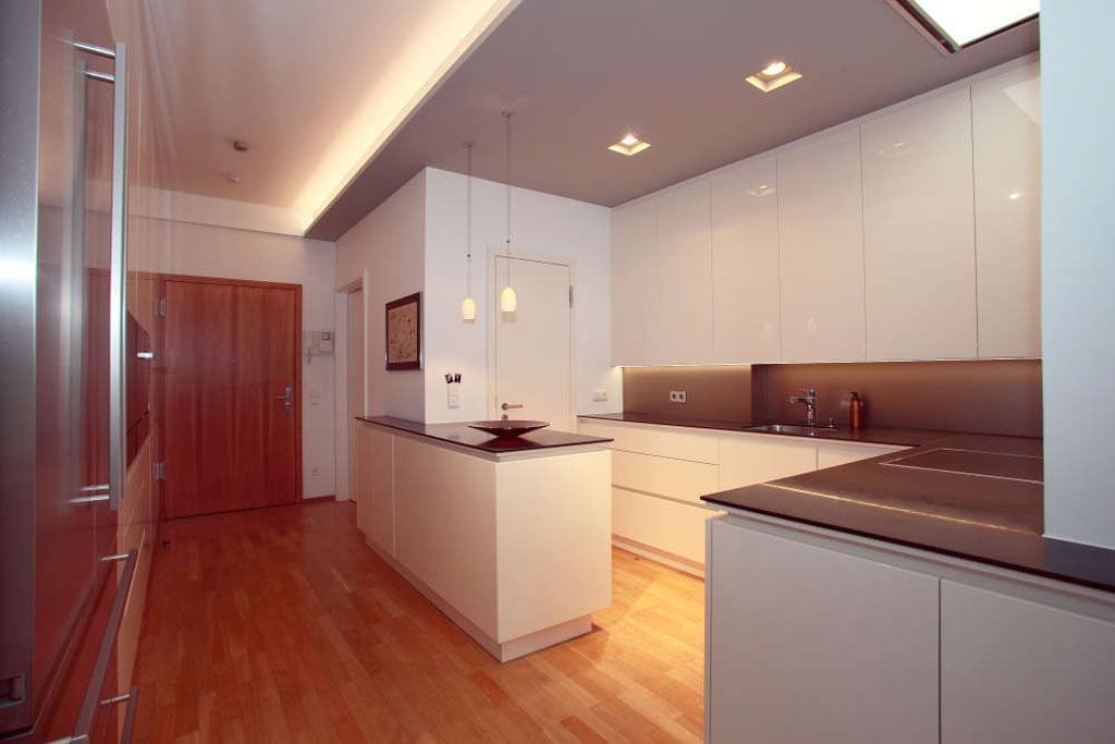 Eine Küche mit weißen Schränken und Holzböden