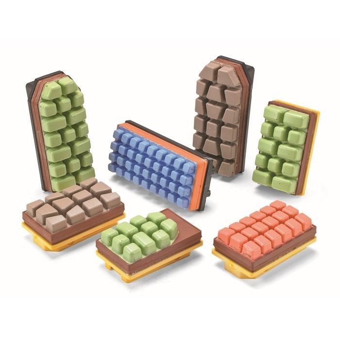 Almohadillas abrasivas rectangulares de varios colores con superficies texturizadas y bases amarillas.
