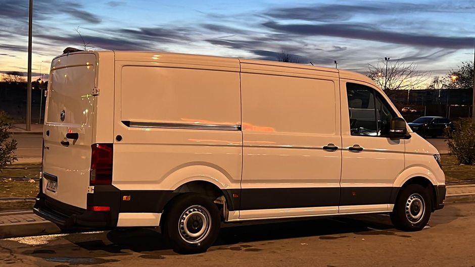 Un camión semirremolque circula por una autopista al atardecer.