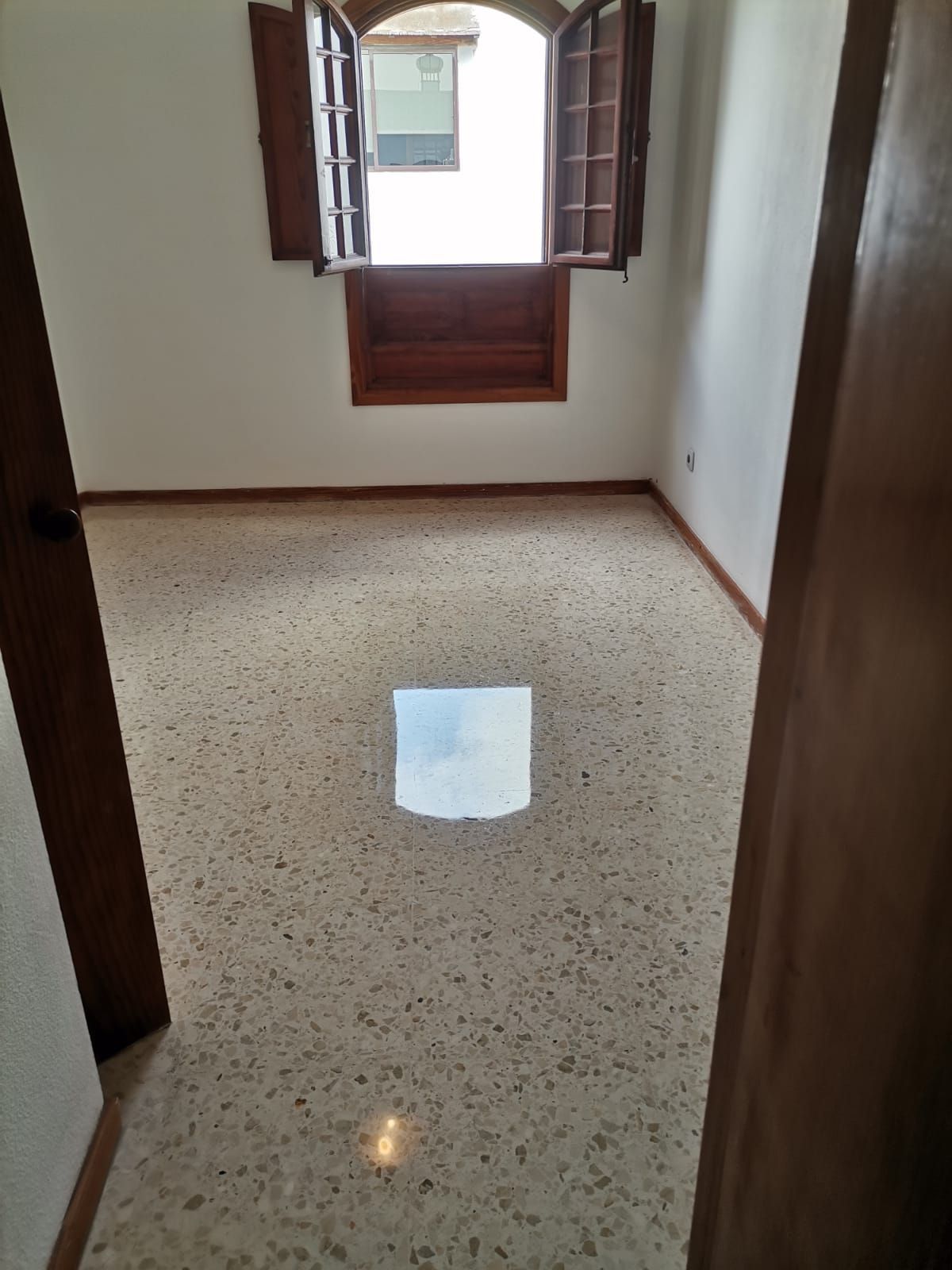 Una habitación vacía con una ventana y una puerta