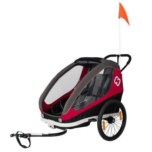 Remorque de vélo pour enfant rouge et noire avec drapeau de sécurité.