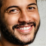 Close de uma pessoa com aparelho, mostrando a língua. A língua é rosa-avermelhada; a pessoa também tem um piercing no nariz.