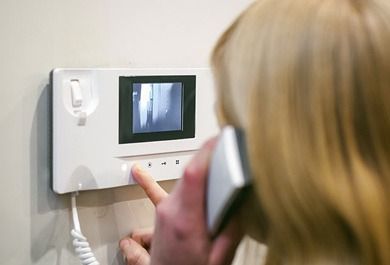 Una mujer está hablando por un videoportero.