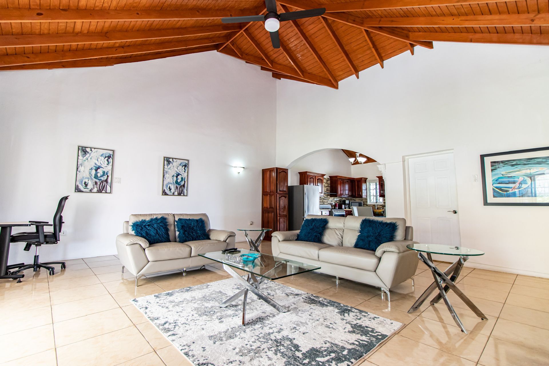 A living room with two couches and a ceiling fan