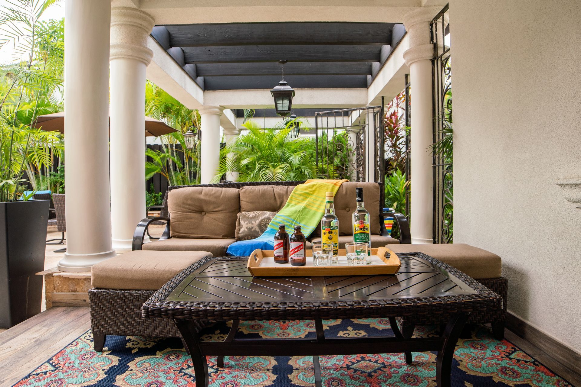 A patio with a couch and a table with drinks on it