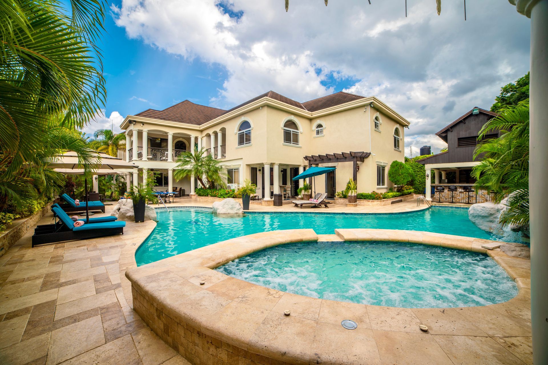 A large house with a large swimming pool in front of it