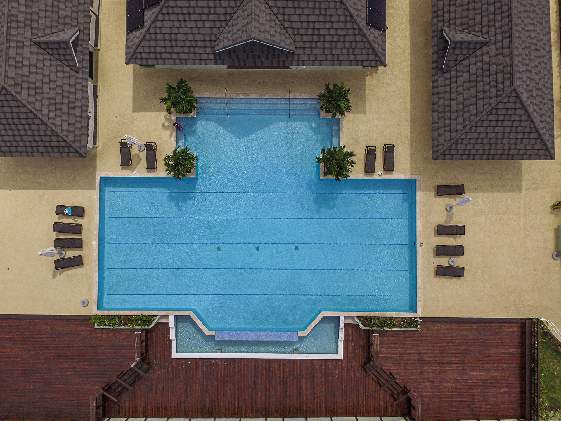 An aerial view of a large swimming pool surrounded by houses