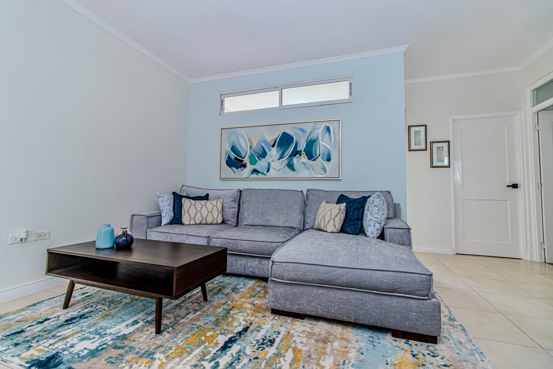A living room with a couch , coffee table , and rug.
