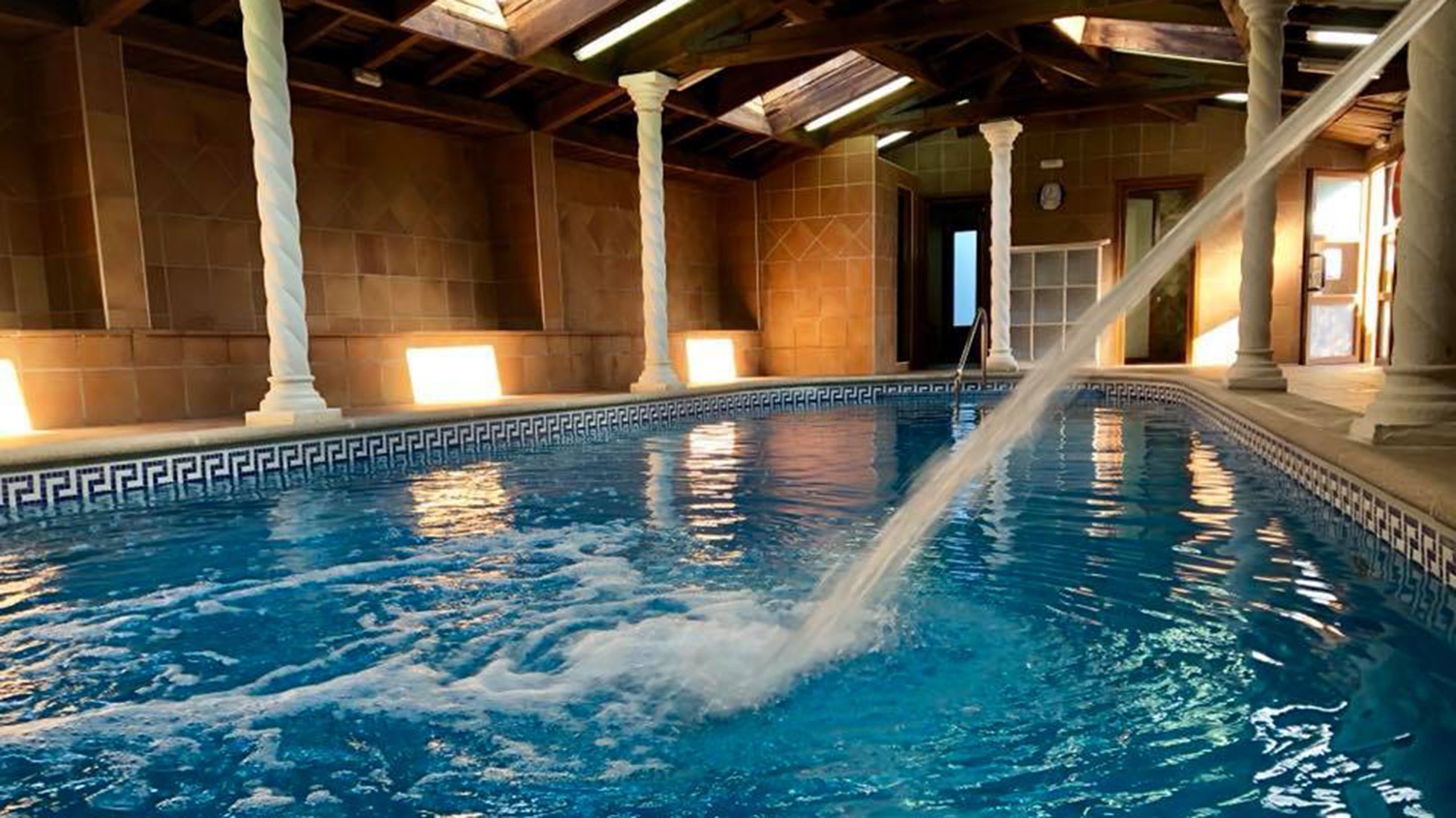 Una gran piscina cubierta con una manguera que arroja agua en ella.