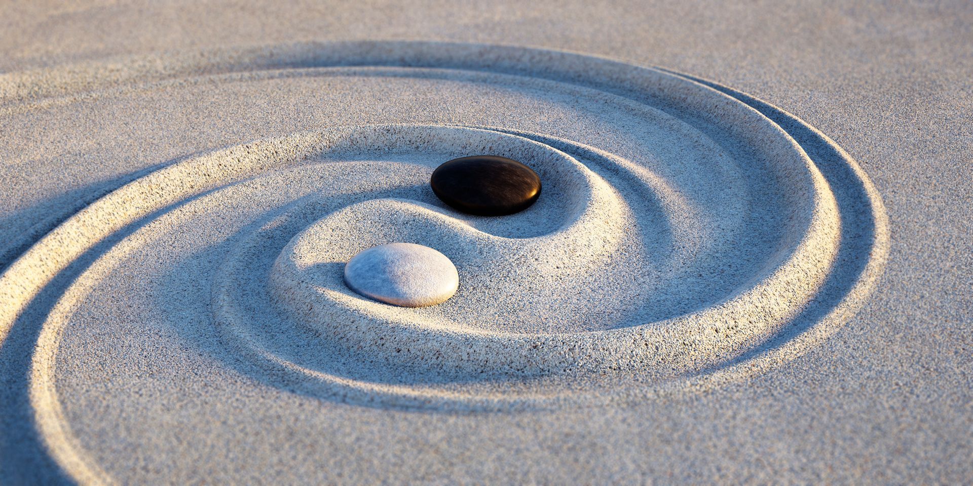 Deux galets noir et blanc qui illustrent le yin et le yang