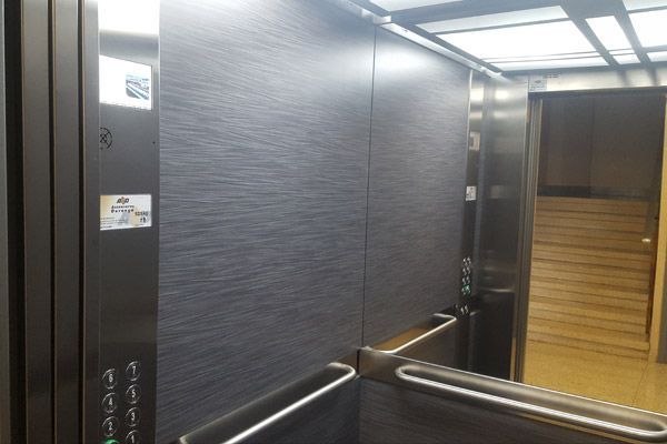 El interior de un ascensor con un espejo y botones.