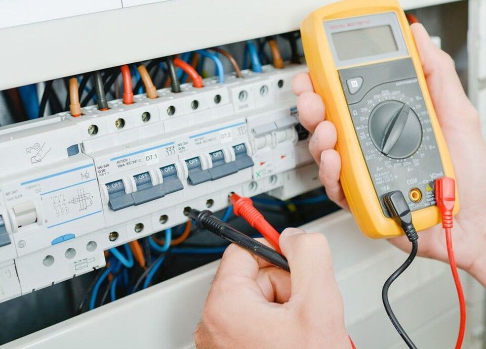 Rickli Elektro GmbH – ein Elektrotechniker prüft mit einem Spannungsprüfgerät den Stromfluss einer Schaltanlage