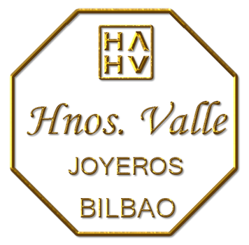 Logotipo octogonal dorado de Hnos. Valle joyeros Bilbao con iniciales estilizadas y texto