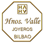 Logotipo octogonal dorado de Hnos. Valle joyeros Bilbao con iniciales estilizadas y texto