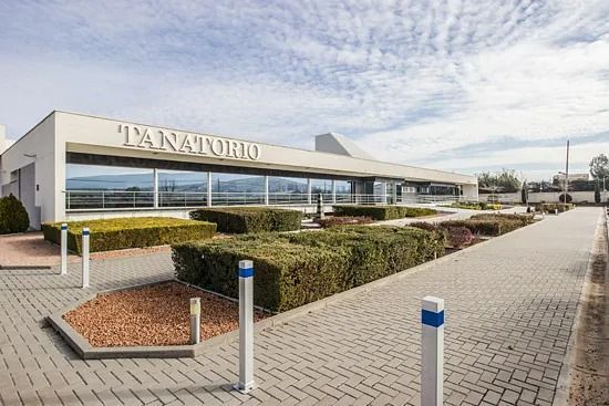 Un gran edificio blanco con la palabra tanatorio en él.