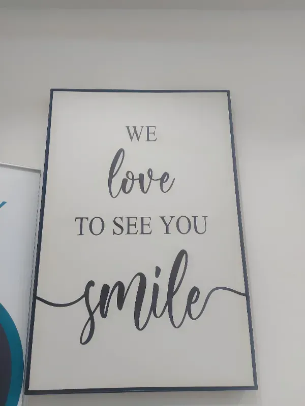 A sign that says we love to see you smile