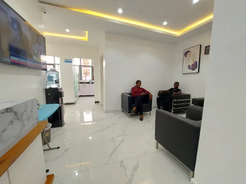 A man is sitting in a chair in a waiting room.