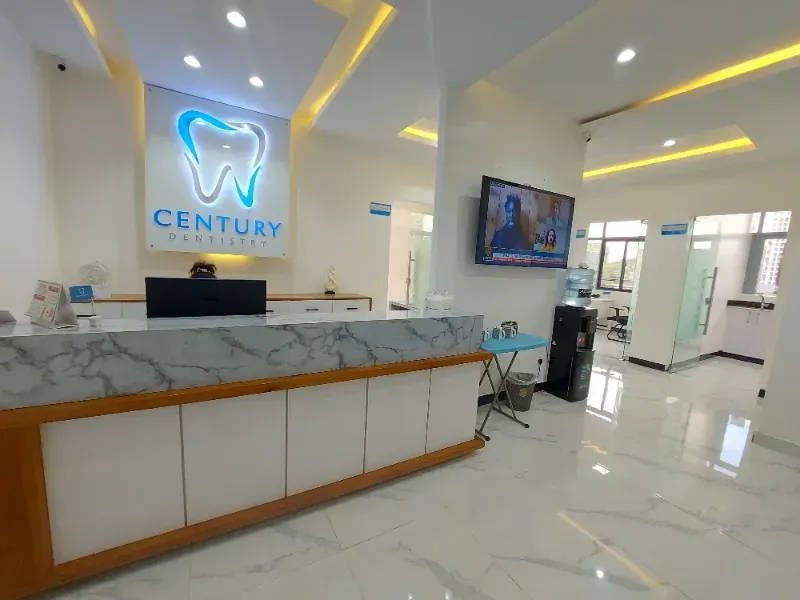 A dental office with a sign on the wall that says century dental clinic.