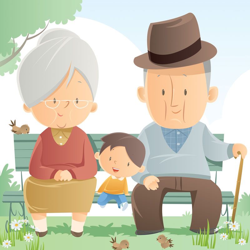 Un couple de personnes âgées assis sur un banc de parc avec un enfant entre eux, entourés de fleurs.