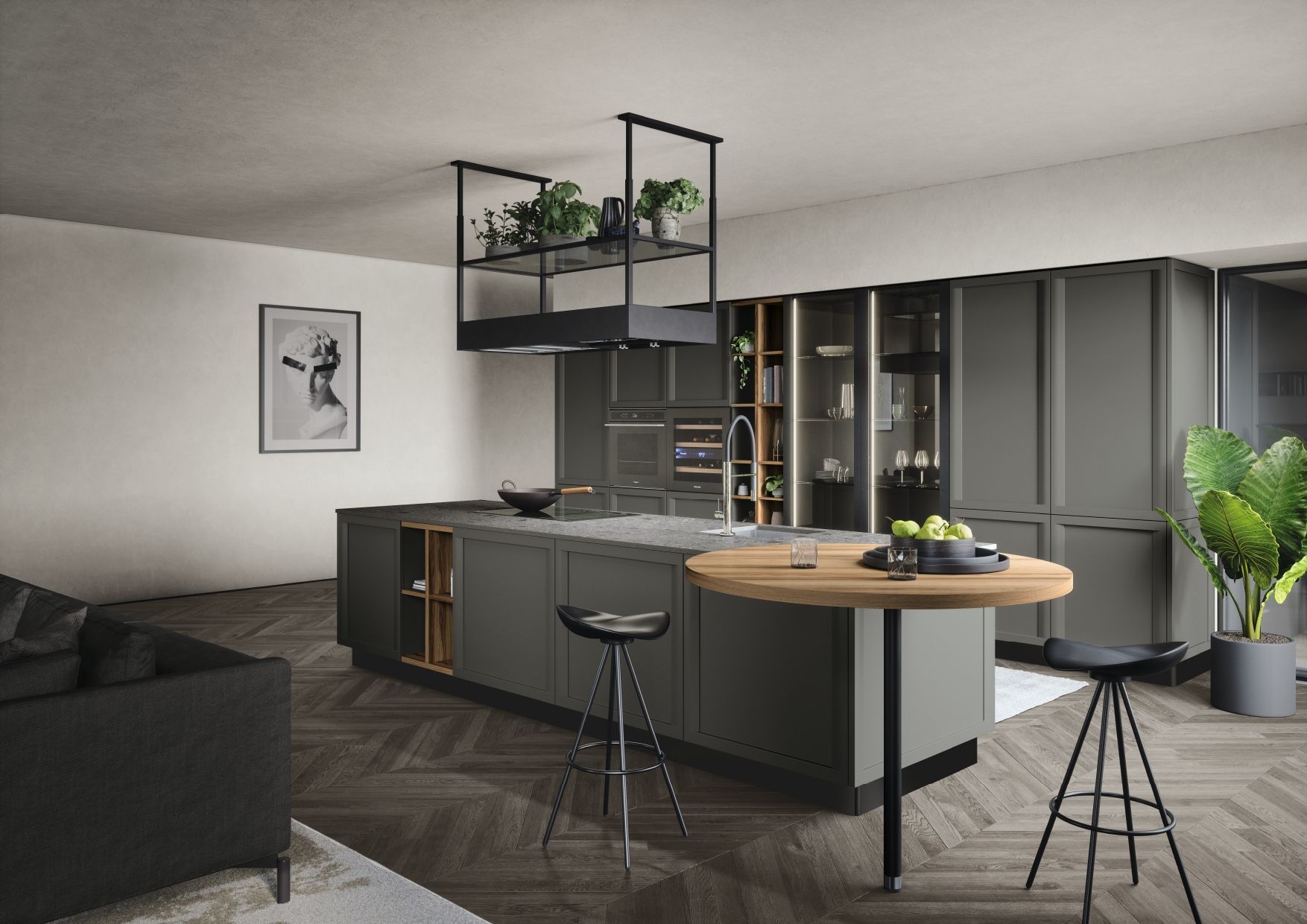 Cuisine moderne avec des placards gris, un îlot en bois, une jardinière suspendue et un tabouret de bar noir, dans un espace de vie ouvert et lumineux