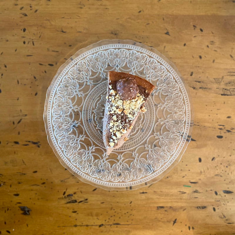Una rebanada de pastel en un plato sobre una mesa de madera