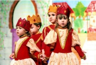 Un grupo de niños vestidos con disfraces y coronas en la cabeza.