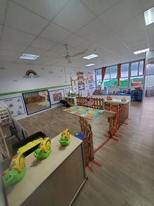 Una habitación grande llena de juguetes y mesas.