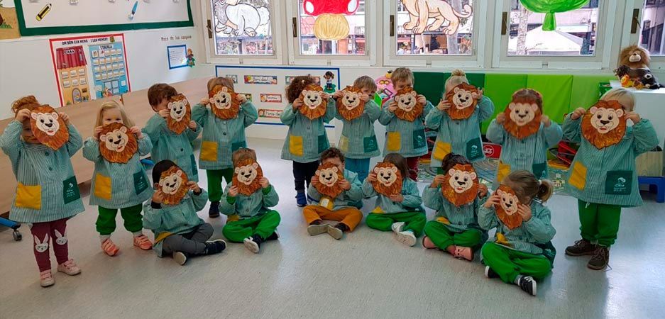 Un grupo de niños con máscaras de león en un aula.