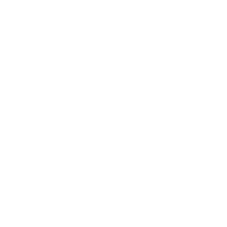 Una máquina expendedora de Coca-Cola roja y blanca se encuentra en una acera junto a un edificio con coloridos murales.