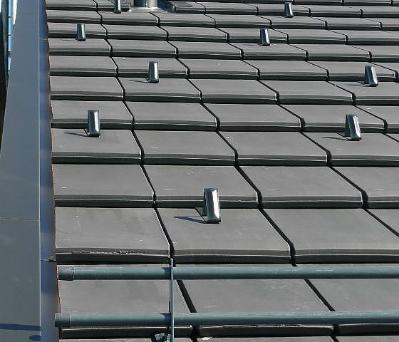 Ein Dach mit vielen Ziegeln und Rohren darauf