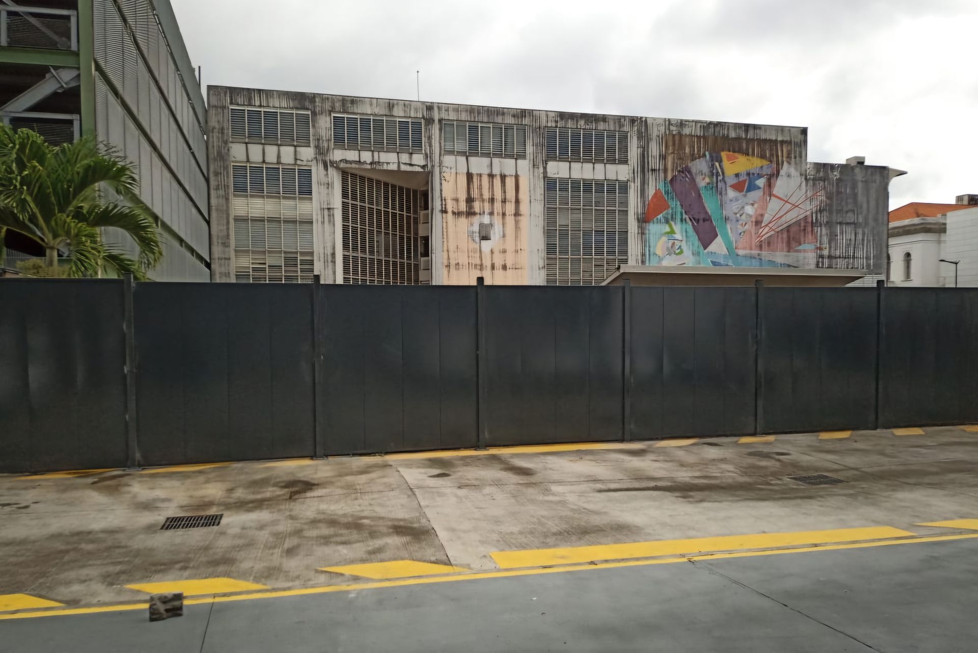 Une haute clôture métallique noire.