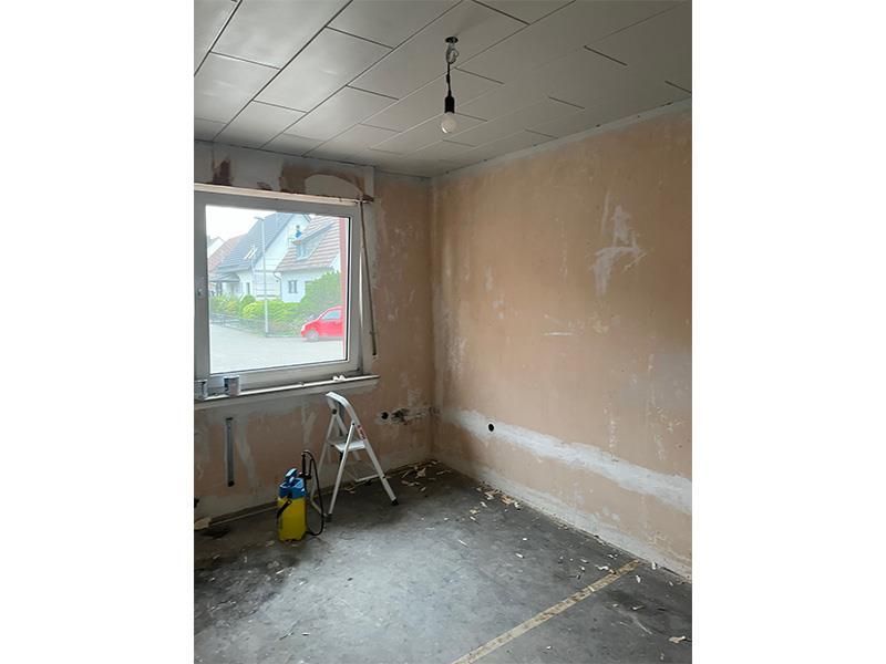 Ein Raum mit einem Fenster und einer Leiter darin.