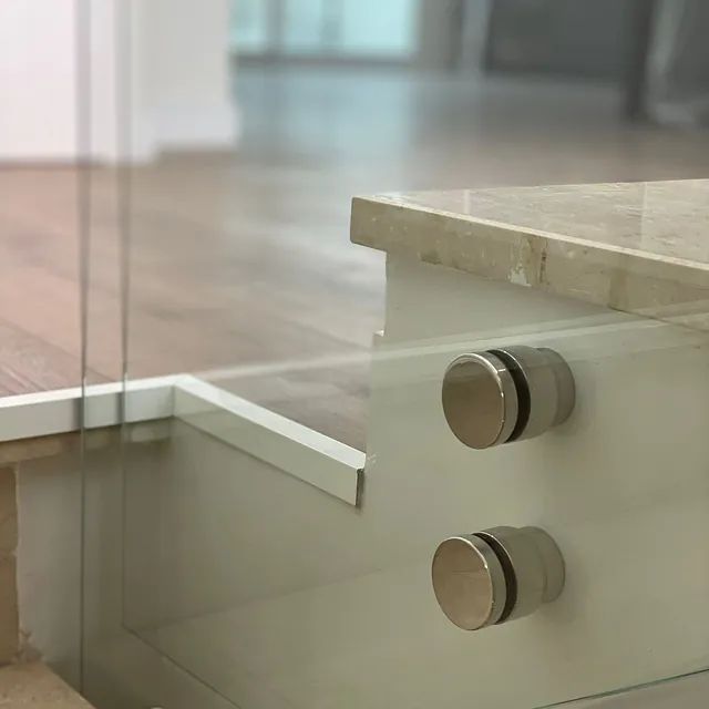 Un primer plano de una barandilla de vidrio en una escalera.