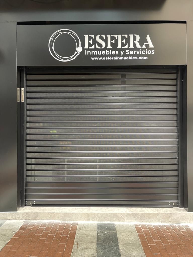 A store front with a sign that says esfera inmuebles y servicios