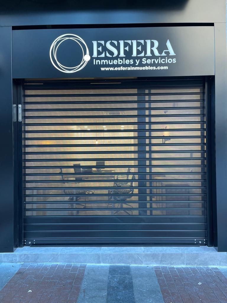 A store front with a sign that says esfera inmuebles y servicios